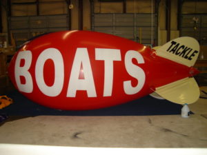 red color blimp with BOATS in white color letters for sale in Texas